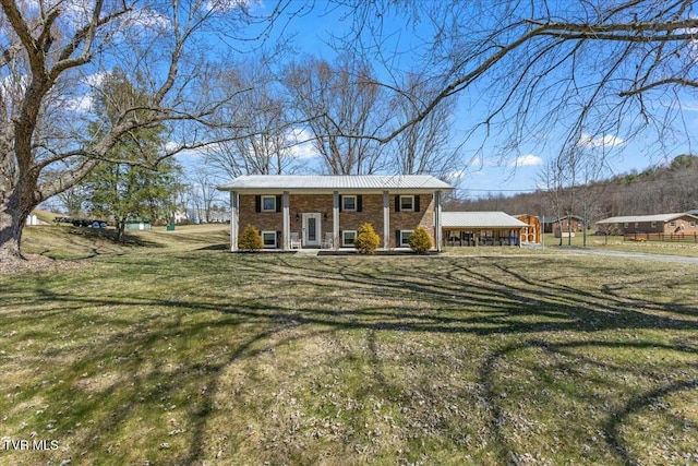 view of front of house with brick siding, a porch, and a front yard