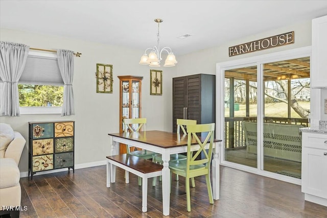 dining space with dark wood finished floors, a notable chandelier, visible vents, and baseboards