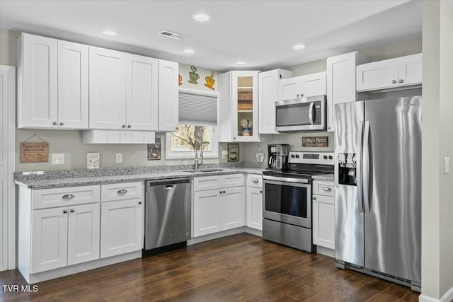 kitchen featuring visible vents, appliances with stainless steel finishes, white cabinets, and dark wood finished floors