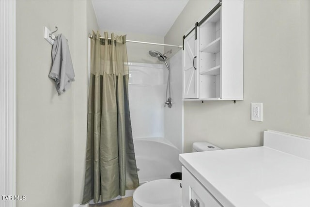 bathroom featuring a stall shower, toilet, and vanity