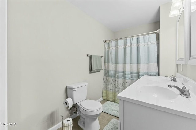 full bath featuring double vanity, toilet, baseboards, and a sink