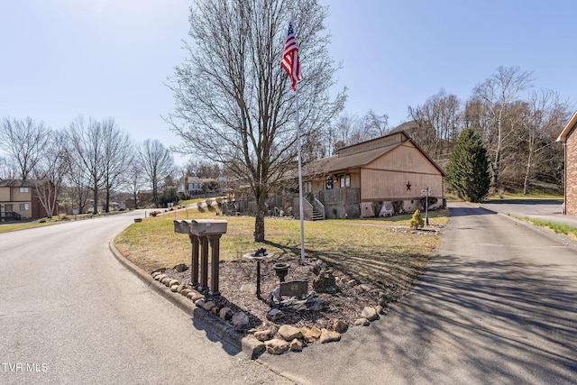 view of front of home with aphalt driveway and a front yard