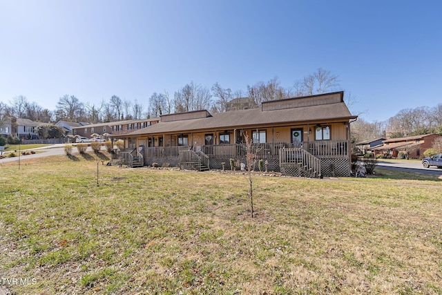 back of house featuring a yard and covered porch