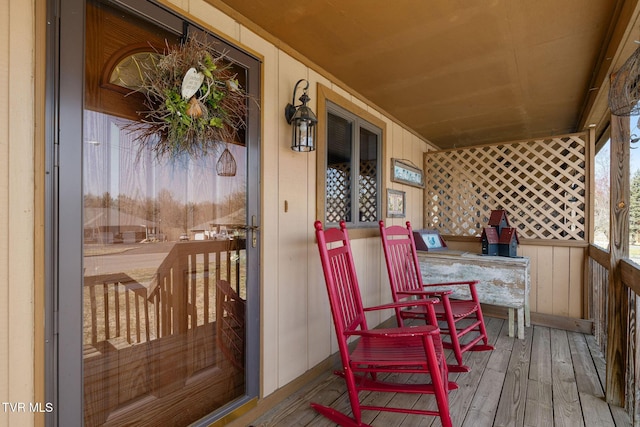 wooden terrace featuring covered porch