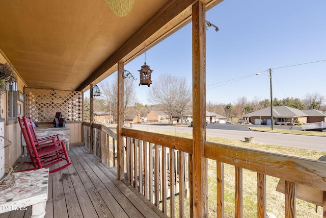 wooden deck featuring a residential view and a porch