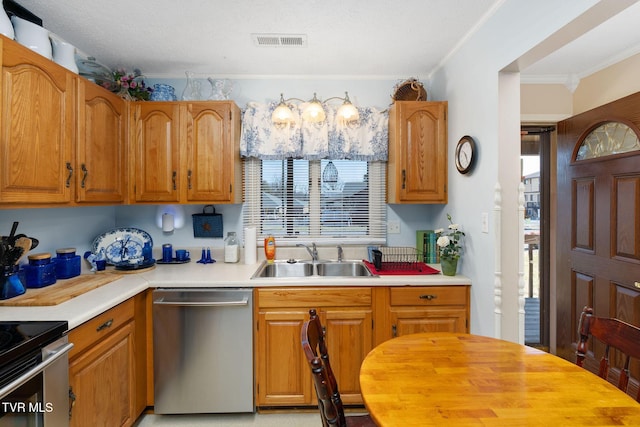 kitchen featuring a healthy amount of sunlight, visible vents, a sink, stainless steel appliances, and light countertops