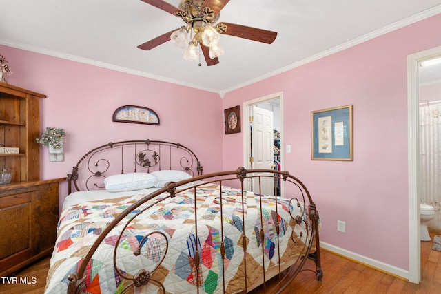 bedroom with light wood-style flooring, a ceiling fan, ornamental molding, ensuite bath, and baseboards