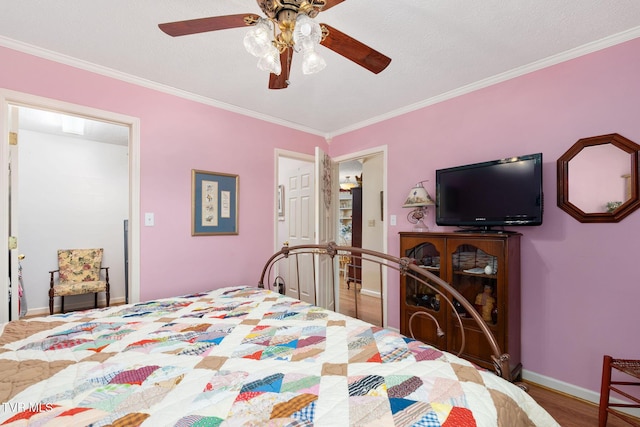 bedroom featuring wood finished floors, baseboards, ornamental molding, and a ceiling fan