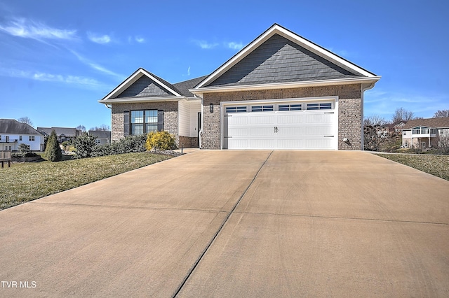 view of front of property with brick siding, an attached garage, and driveway