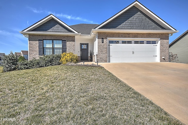 view of front facade featuring brick siding, a front yard, an attached garage, and driveway