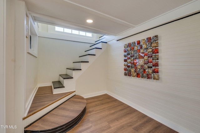 stairs with recessed lighting, wood finished floors, and baseboards