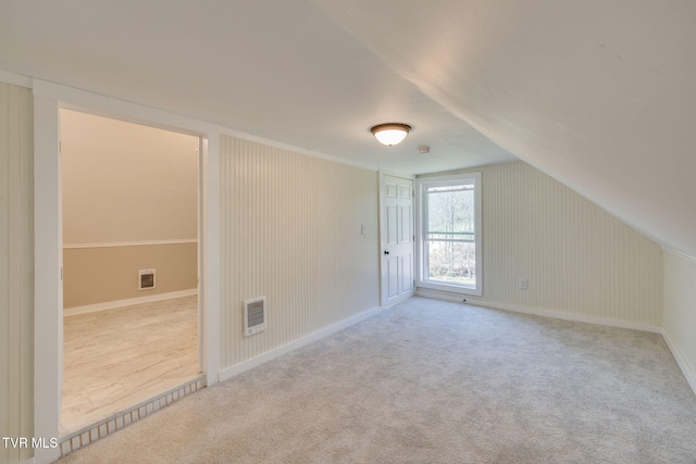 additional living space with visible vents, carpet flooring, and baseboards