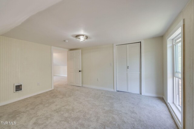 unfurnished bedroom with baseboards, visible vents, carpet floors, and a closet