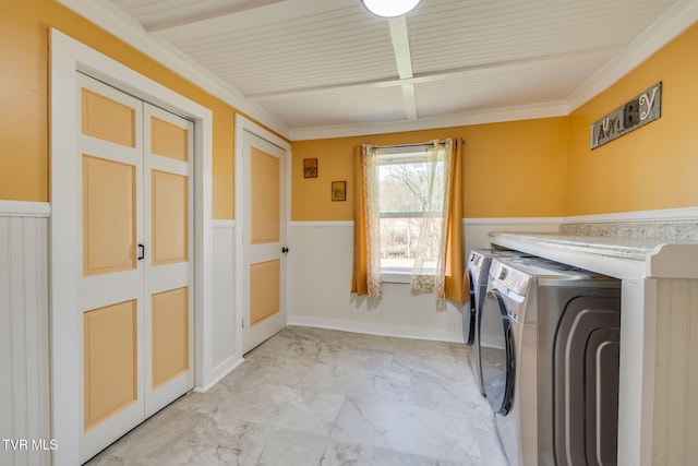 clothes washing area with independent washer and dryer, laundry area, a wainscoted wall, and marble finish floor