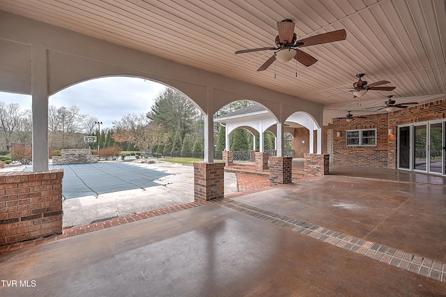 view of patio featuring a covered pool and a ceiling fan