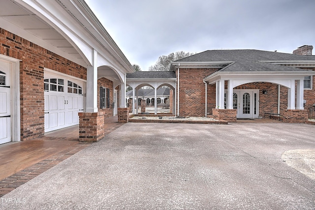 view of patio with french doors and driveway