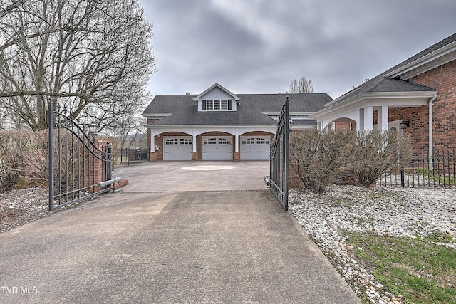 exterior space with a garage, fence, brick siding, and driveway