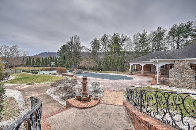 view of pool featuring a fenced in pool, a porch, fence private yard, a yard, and a patio