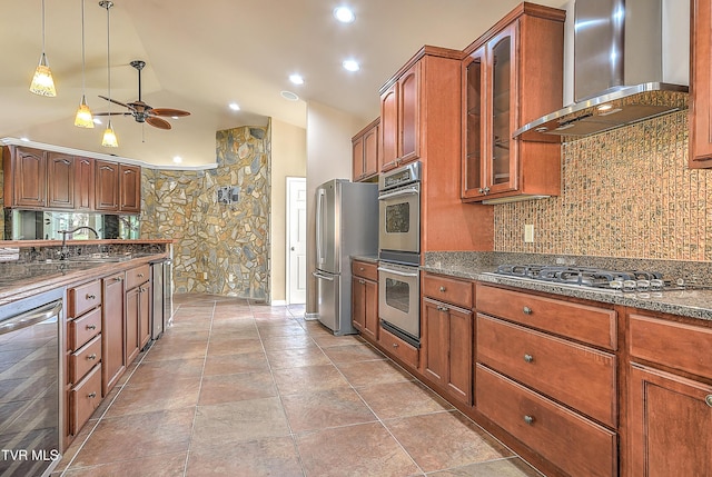 kitchen with a sink, stainless steel appliances, wine cooler, wall chimney exhaust hood, and ceiling fan