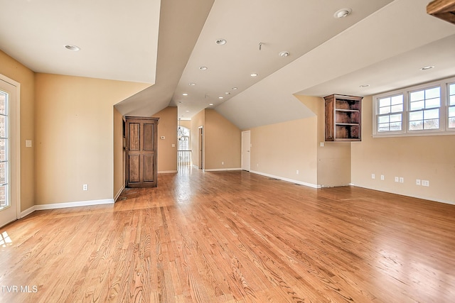 interior space featuring recessed lighting, baseboards, light wood-style floors, and vaulted ceiling