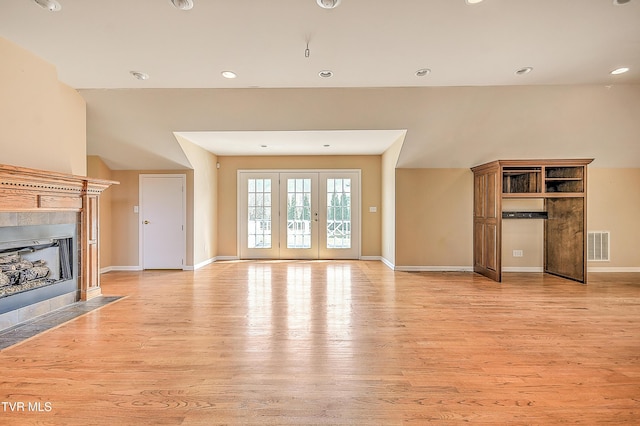 unfurnished living room featuring visible vents, light wood-style flooring, recessed lighting, a fireplace, and baseboards