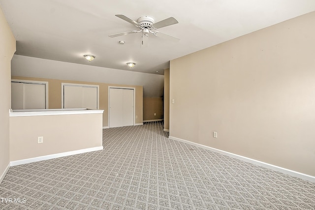 unfurnished room featuring baseboards, light colored carpet, and ceiling fan