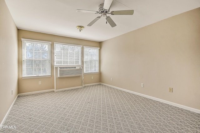 unfurnished room featuring light carpet, ceiling fan, cooling unit, and baseboards