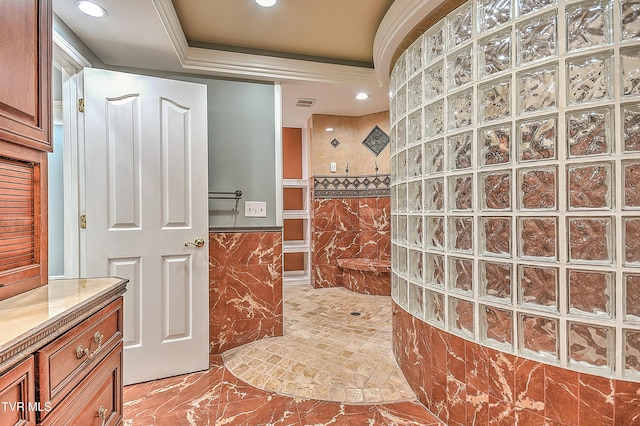 full bathroom featuring ornamental molding, a tray ceiling, recessed lighting, tile walls, and walk in shower