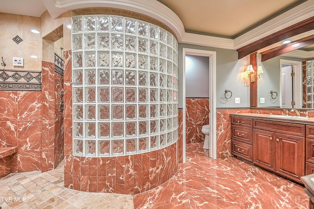 full bathroom featuring tile walls, ornamental molding, wainscoting, and a walk in shower