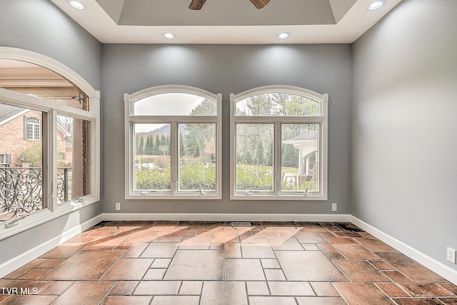 empty room featuring a wealth of natural light, recessed lighting, baseboards, and ceiling fan