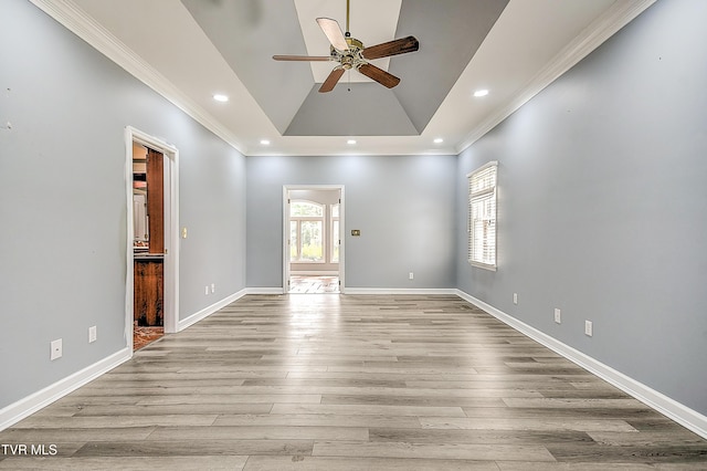 spare room featuring baseboards, recessed lighting, ceiling fan, light wood-style floors, and crown molding