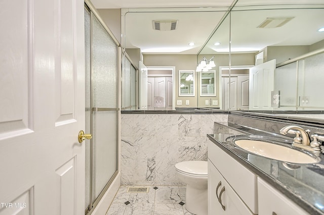 bathroom featuring visible vents, marble finish floor, a shower stall, and vanity