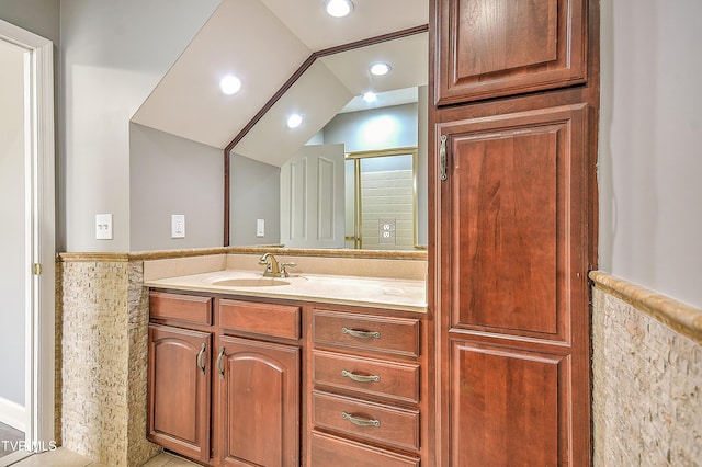 bathroom featuring vanity, lofted ceiling, an enclosed shower, and recessed lighting