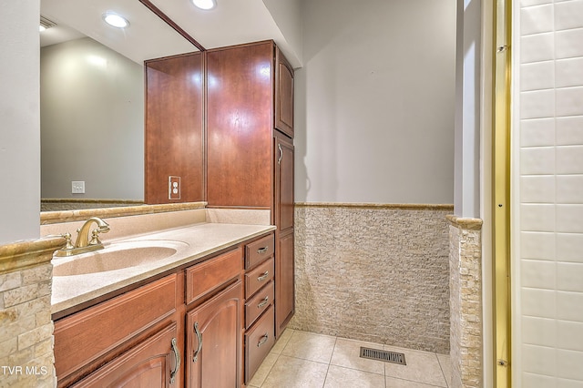 bathroom with visible vents, recessed lighting, wainscoting, tile patterned floors, and tile walls