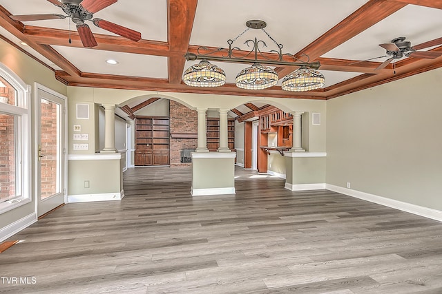 unfurnished living room featuring wood finished floors, decorative columns, a ceiling fan, and coffered ceiling