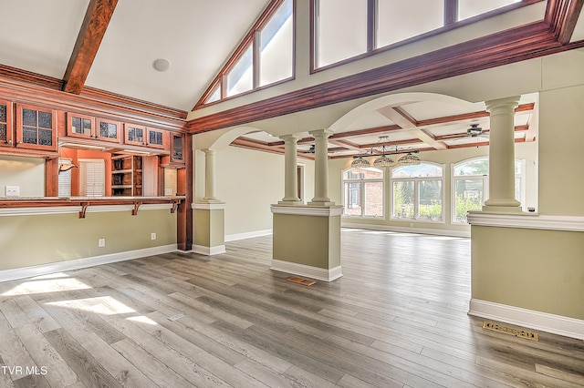 unfurnished living room featuring coffered ceiling, wood finished floors, baseboards, and decorative columns