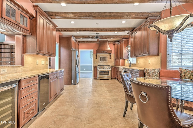 kitchen featuring light stone countertops, a ceiling fan, wine cooler, custom range hood, and appliances with stainless steel finishes