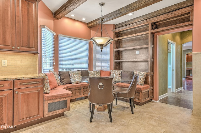 dining room with beam ceiling, recessed lighting, and built in shelves