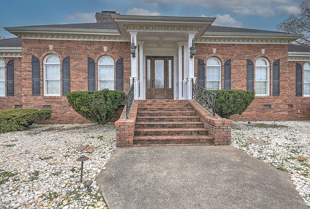 view of front of house with crawl space, brick siding, and roof with shingles