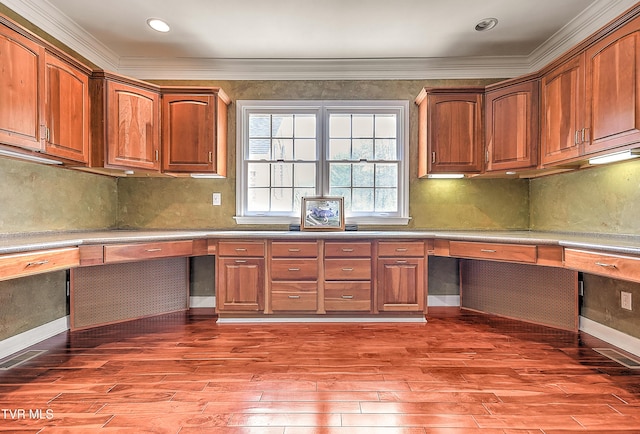 kitchen with light wood-style flooring, built in desk, and backsplash