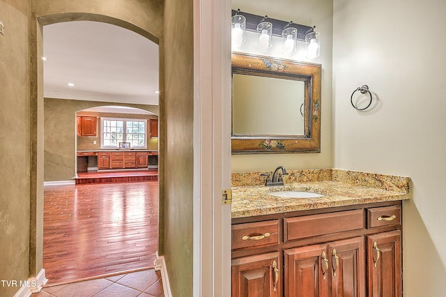 bathroom featuring baseboards, vanity, and tile patterned flooring