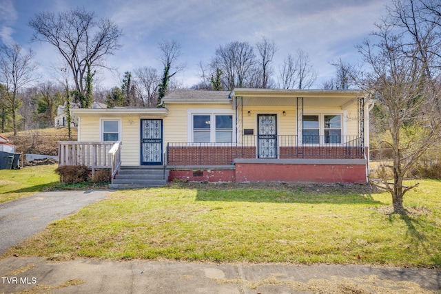 bungalow featuring a porch, brick siding, and a front lawn