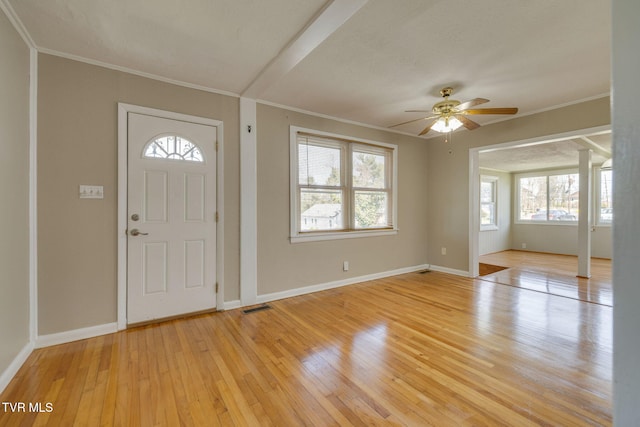 foyer featuring visible vents, light wood-style flooring, crown molding, and baseboards