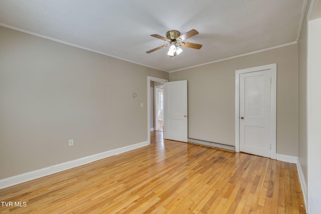 empty room featuring light wood-type flooring, a baseboard radiator, baseboards, and ornamental molding