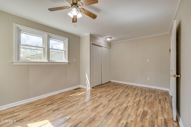 interior space with hardwood / wood-style floors, baseboards, a closet, and ornamental molding