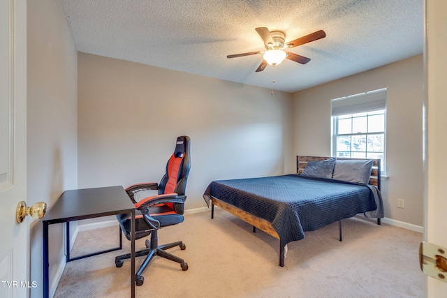 carpeted bedroom featuring ceiling fan, a textured ceiling, and baseboards