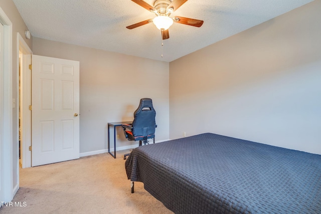 carpeted bedroom featuring baseboards, a textured ceiling, and ceiling fan