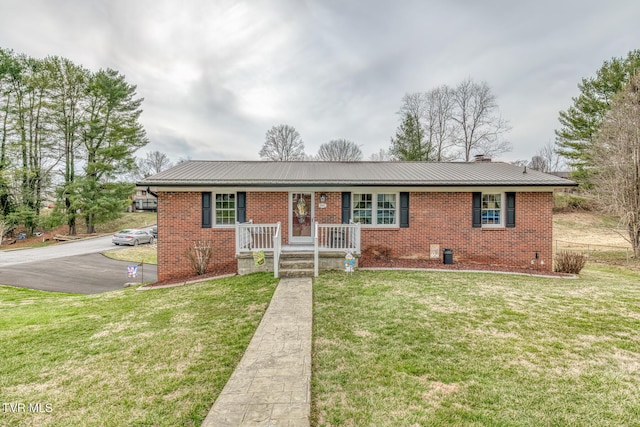 ranch-style home featuring a front lawn, a porch, brick siding, and metal roof