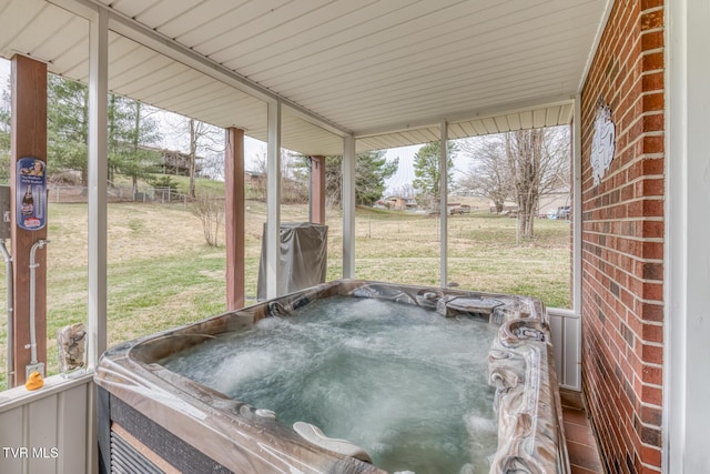 unfurnished sunroom with a hot tub