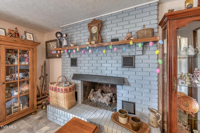 room details featuring a fireplace, visible vents, and a textured ceiling